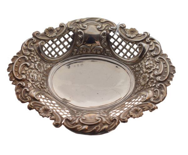 Late Victorian silver bon bon dish of wavy oval design with floral repoussé decoration and pierced