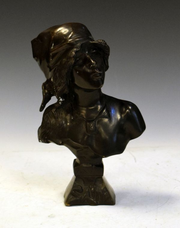 Bronze bust of a maiden wearing a headscarf on spreading square socle Condition: