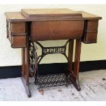 Oak cased Singer sewing machine with cast iron treadle base Condition: