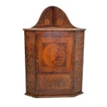 Interesting late 19th/early 20th Century pyrography-decorated corner cupboard, the arched