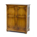 Early to mid 20th Century low press cupboard of geometric panelled form with twin doors enclosing