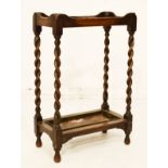 Early 20th Century oak two division stickstand with barley twist uprights flanking drip tray
