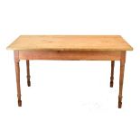 Pine refectory style kitchen table with rounded oblong top on four turned tapering supports, to seat
