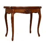 19th Century French walnut fold over top serpentine card table having carved apron, raised on knee