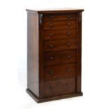 Late Victorian oak Wellington chest of seven drawers with hinged lockable vertical strip on plinth