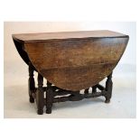Early 18th Century style oak drop leaf gateleg dining table with oval flaps and two short frieze
