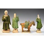 Four Chinese terracotta glazed figures, the tallest standing 26cm high Condition: