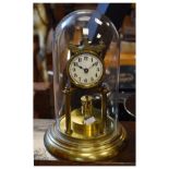 Mid 20th Century brass anniversary or torsion clock with white Roman dial and circular revolving