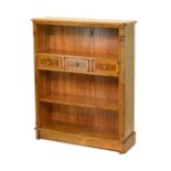 Reproduction walnut finish open bookcase fitted three short drawers with adjustable shelf below,