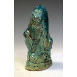 Turquoise glazed pottery figure of a lion holding a shield, 19cm high Condition: