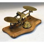 Brass postage scale on shaped beech base with brass weights Condition: