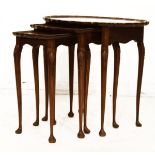 Mid 20th Century nest of three walnut occasional tables, each of wavy oval form having a quarter top