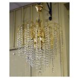 Set of four brass ceiling lights, each with brass spokes and two bands of lustre drops framing three