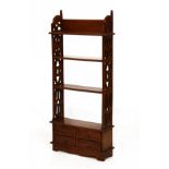 Reproduction mahogany open bookcase of three shelves between fret work sides over four short drawers