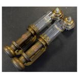 Pair of brass wall lanterns, each with glass cylindrical chimney over oval GWR plaque Condition:
