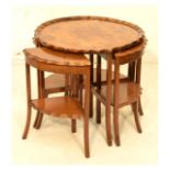 20th Century nest of walnut occasional tables, each of pie-crust design, the largest of wavy