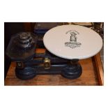 Set of grocer's cast iron scales having a black transfer printed ceramic platform decorated with the