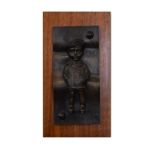20th Century bronze - plaque depicting a schoolboy wearing cloth cap and blazer, mounted on a