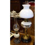 Early 20th Century brass paraffin lamp having a white milk glass shade and reservoir over column