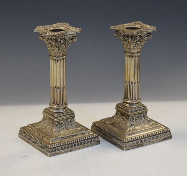 Pair of Edward VII silver candlesticks of Corinthian column design with stop-fluted stem,