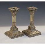 Pair of Edward VII silver candlesticks of Corinthian column design with stop-fluted stem,