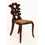 Victorian walnut child's chair having carved monogram back C.H., with upholstered seat, raised on