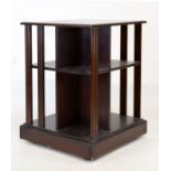20th Century mahogany revolving bookcase of typical square design with moulded struts and assorted
