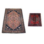 Two small Middle Eastern wool rugs, the larger with terracotta field, indigo spandrels and multi