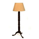 Carved walnut standard lamp with foliate stem on tripod support, together with a pleated silk