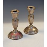 Pair of George V table candlesticks, each with urn shaped stem on domed foot, Birmingham 1934,