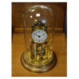 Mid 20th Century brass anniversary or torsion clock having a white Arabic dial and four-ball