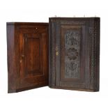 Two George III oak wall hanging corner cabinet one with later carved foliate decoration, the other