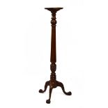 20th Century mahogany torchère or plantstand, the dished circular top on fluted stem and tripod