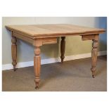 Late 19th/early 20th Century oak draw-out dining table with additional leaf on reeded tapering