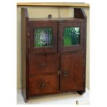 Early 20th Century oak wall cabinet having a pair of green glazed doors over long door beside two