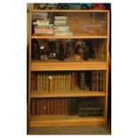 Mid 20th Century golden oak bookcase of four tier design in two sections, each with sliding doors