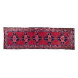 Good quality modern Turkish wool runner decorated with five geometric medallions on a red ground