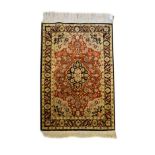 Small Middle Eastern/Indian silk rug, the brick red field with central lobed medallion within