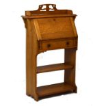 Edwardian lady's light oak bureau, the fall flap opening to reveal a partially fitted interior,