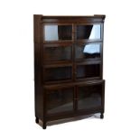 Oak four tier sectional bookcase having hinged glazed doors Condition: