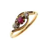 18ct gold ring of crossover design set central ruby-coloured stone between two diamonds, size M½,