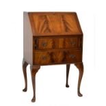 Reproduction mahogany finish bureau fitted fall flap with two drawers below and standing on cabriole