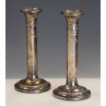 Pair of Edward VII silver cylindrical candlesticks having ribbon and swag decoration, Birmingham