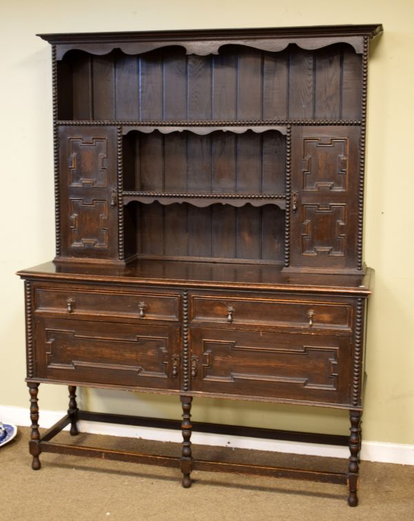 1920's period oak Jacobean Revival high dresser, the plate rack fitted two shelves and two