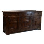 Good quality old reproduction carved oak low dresser fitted three drawers to the frieze with