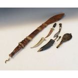 North African sword in a leather scabbard, two ornamental daggers and a powder flask Condition: