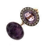 Unmarked yellow metal dress ring set large faceted oval amethyst-coloured stone within seed pearl