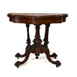Victorian walnut and figured walnut serpentine front fold-over card table standing on a turned