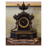 Victorian cast brass mounted black slate cased mantel clock, the elaborate mounts with mask head