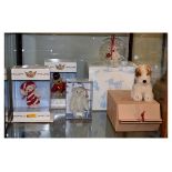 Three modern Steiff miniature teddy bears, a replica Foxy terrier and a miniature bear in a glass